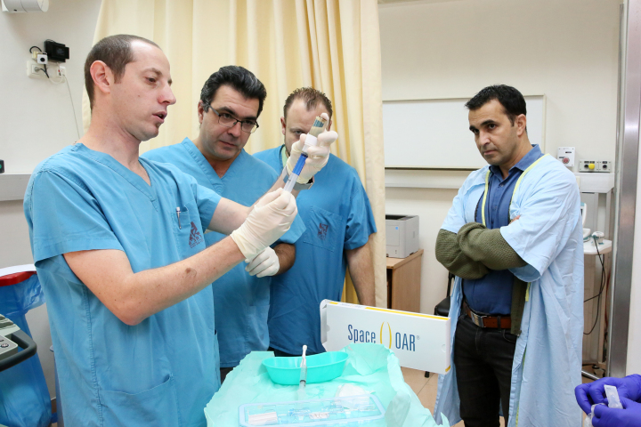 Dr. Charas prepares a bio-compatible gel treatment at Rambam. Credit: Pioter Fliter.