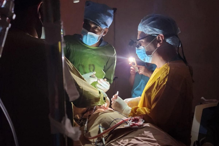 Performing surgery with smartphone flashlights in the operating room of St. Peter’s Hospital in Ethiopia. Photography: Courtesy of Dr. Vasila Rechea.