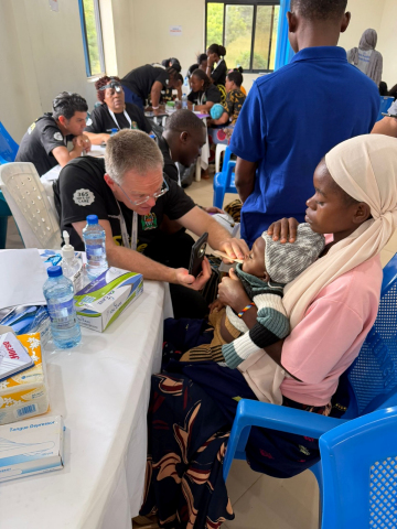 Dr. Sharoni examining a child in Tanzania.