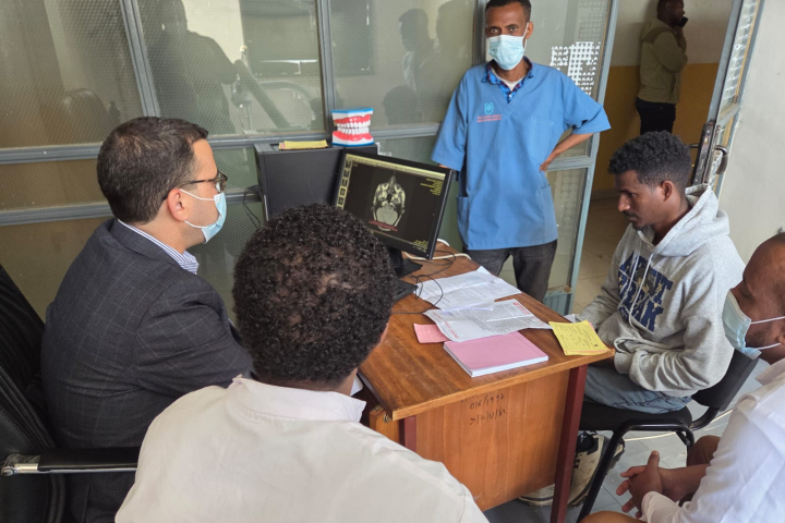 Dr. Taha (facing the computer screen) during a preoperative consultation.
 Photography: Rambam HCC